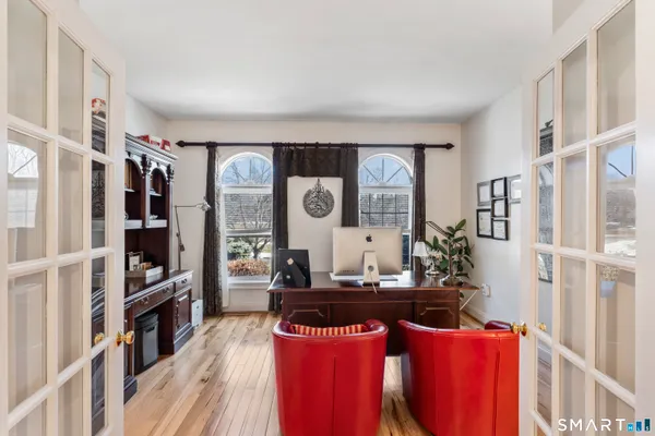a living room with furniture and wooden floor