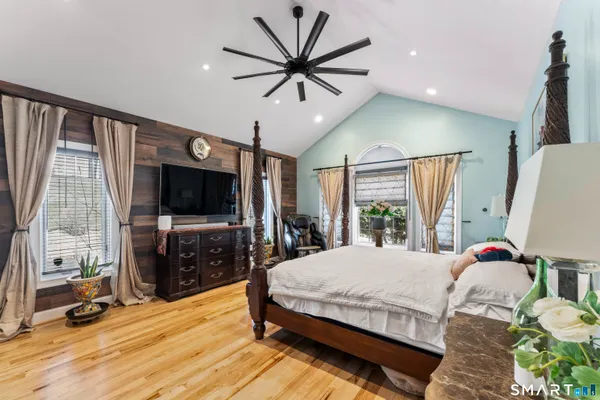 a bedroom with a bed and a flat screen tv