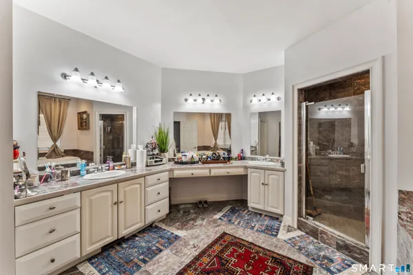 a large bathroom with a double vanity sink mirror and shower