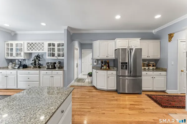 a kitchen with refrigerator and cabinets