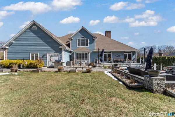a view of a house with swimming pool and sitting area