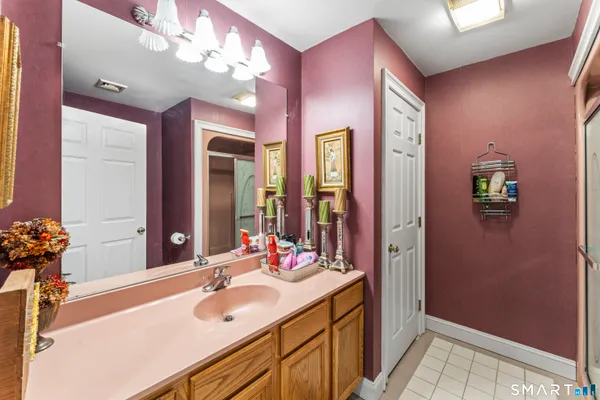 a bathroom with a sink vanity and a mirror