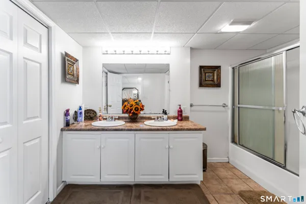 a view of a hallway that has a refrigerator and a sink