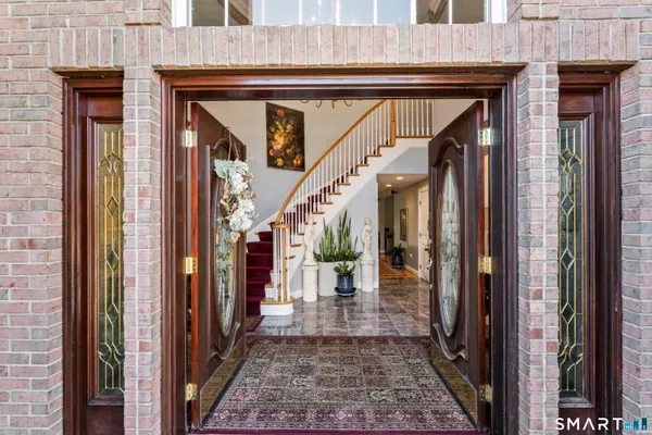 a view of a hallway with wooden floor and a glass door
