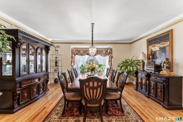 a dining room with furniture a window and a chandelier