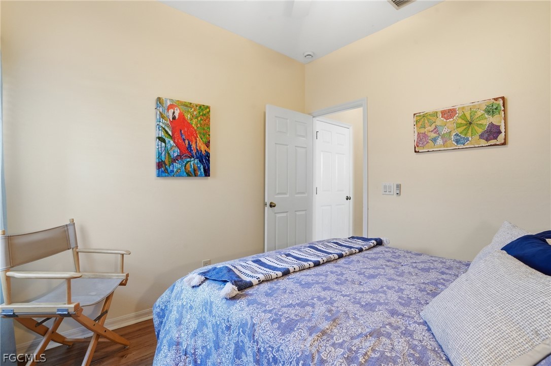 10730 Rio Mar Circle Estero, FL 33928 - Photo 20 of 47 a bedroom with a bed and painting on the wall