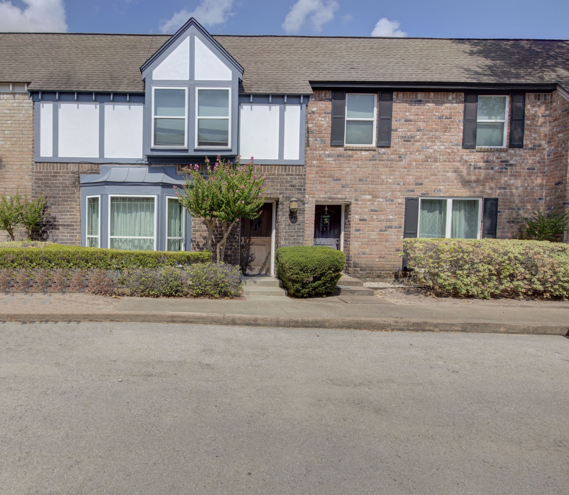 840 Threadneedle Street, Unit 208 Houston, TX 77079 - Photo 1 of 31 a front view of a house with a yard and garage