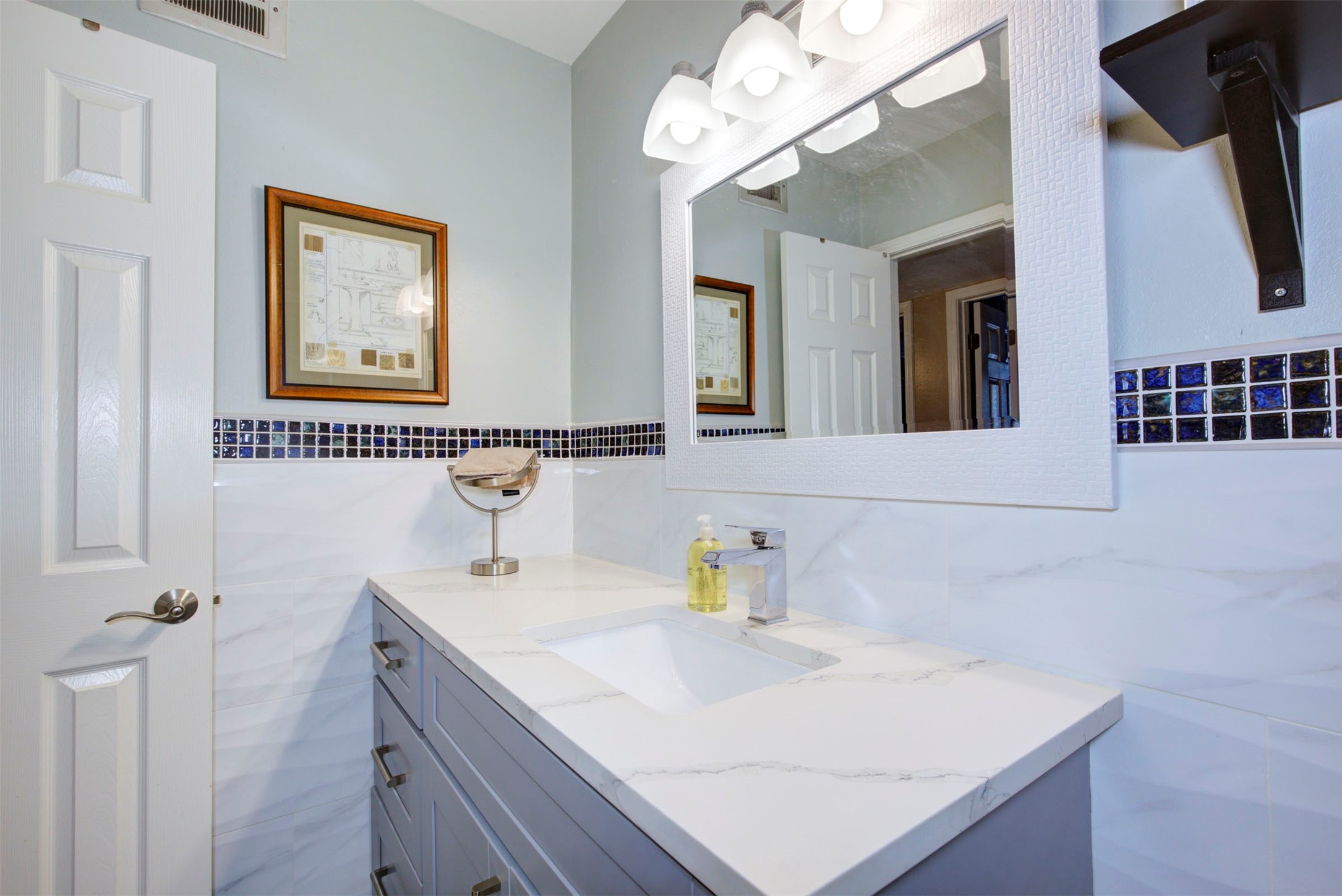 840 Threadneedle Street, Unit 208 Houston, TX 77079 - Photo 22 of 31 a bathroom with a sink a large mirror and a shower