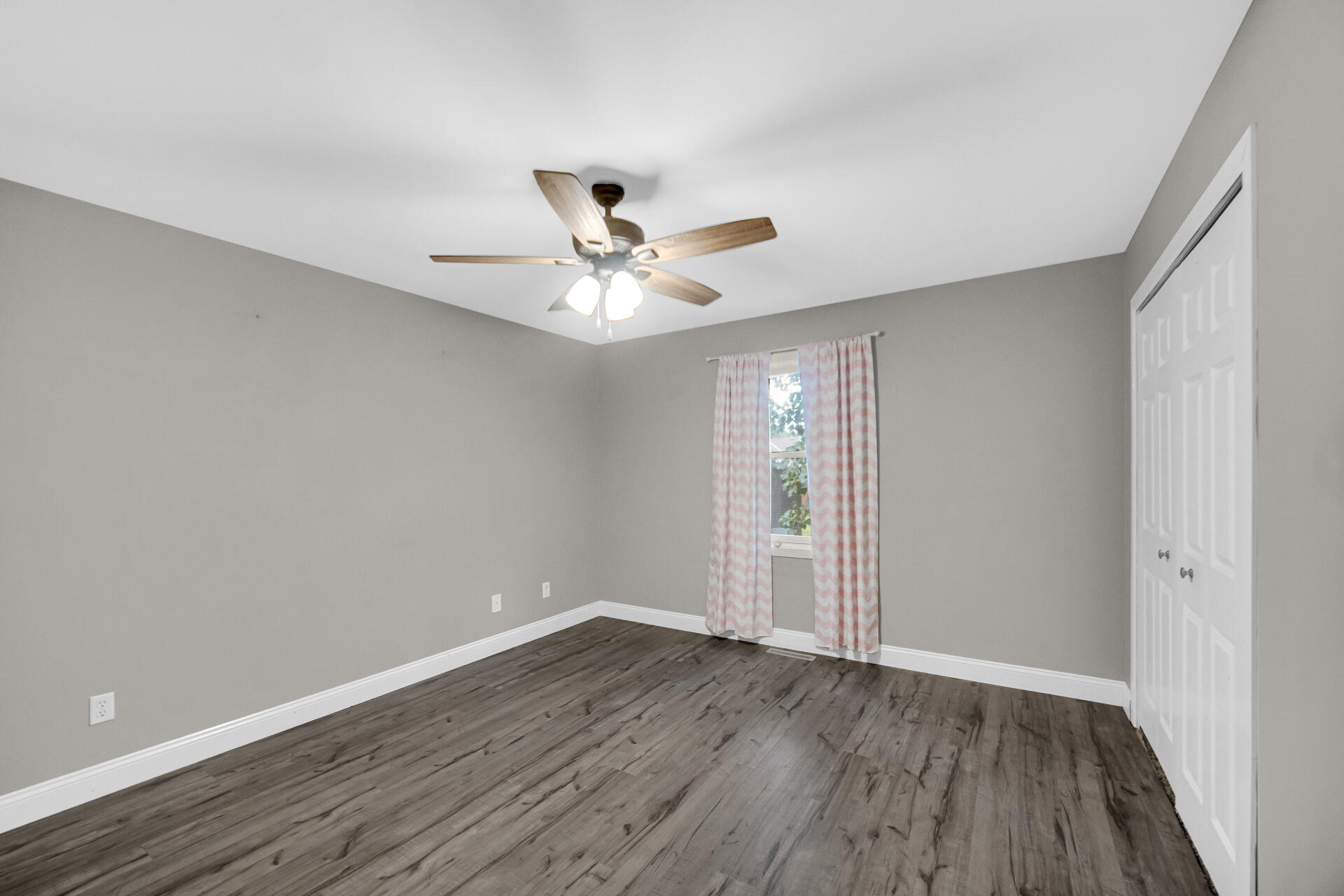 3716 Walsh Street Portage, IN 46368 - Photo 12 of 24 an empty room with wooden floor and ceiling fan