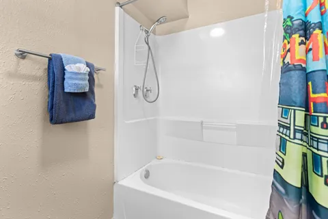 a bathroom with a bathtub and a shower