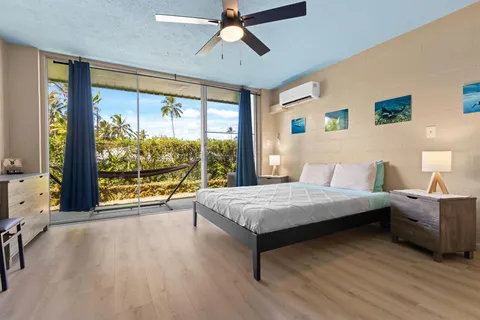 a spacious bedroom with a bed and large window