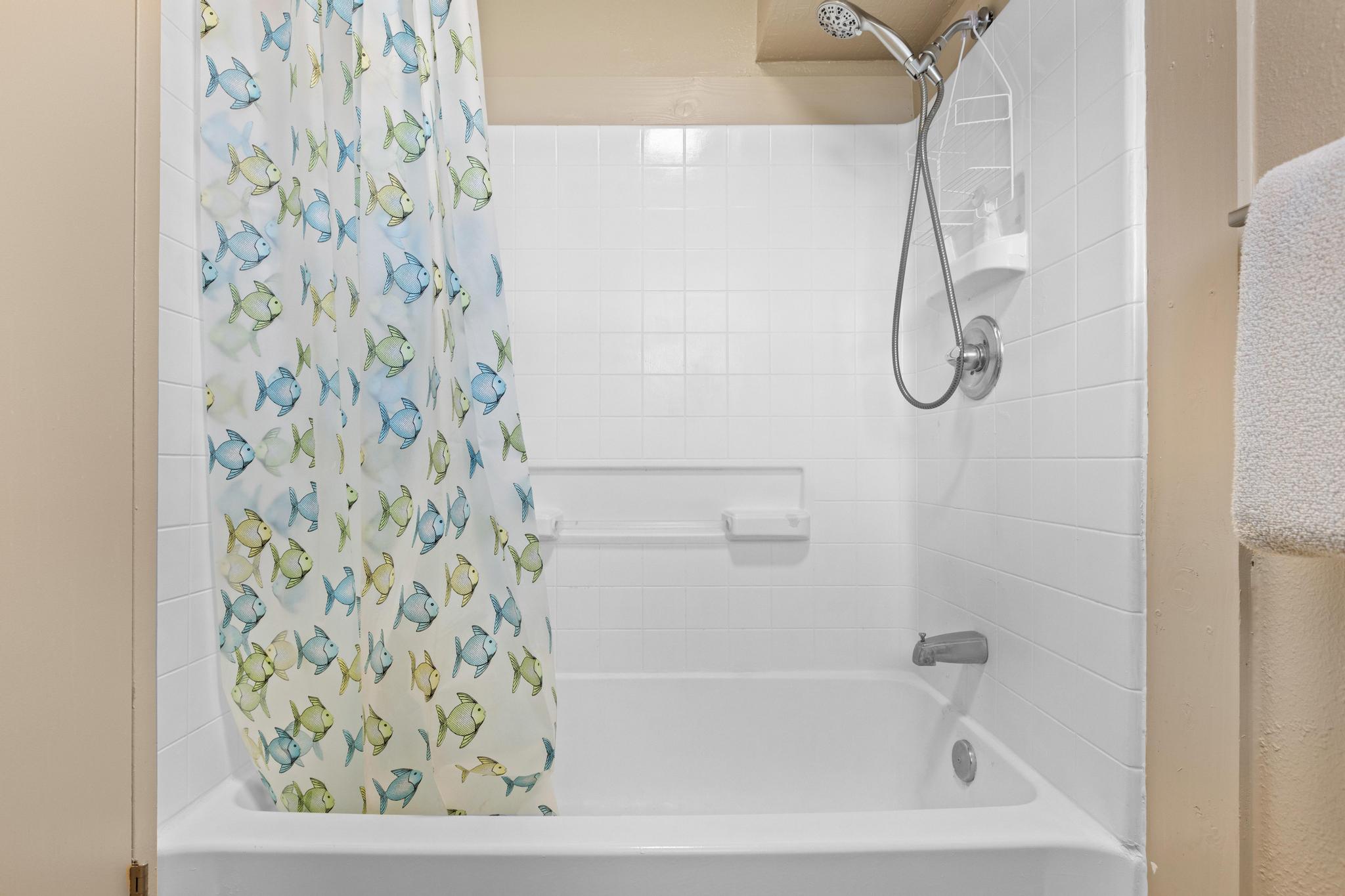 1303 Kalanianaole Street, Unit 112 Hilo, HI 96720 - Photo 18 of 27 a bathroom with a bathtub and shower
