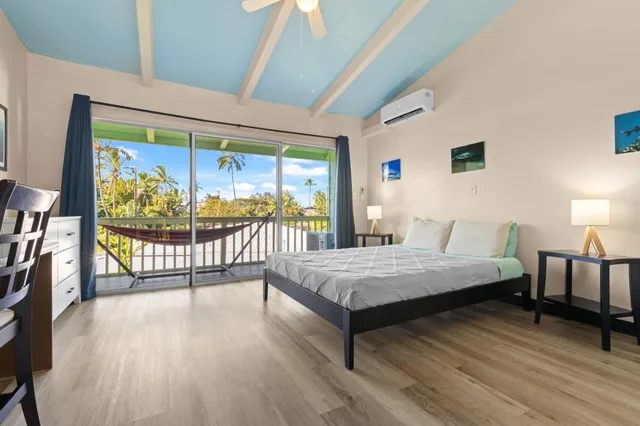 a bedroom with a bed and a large window