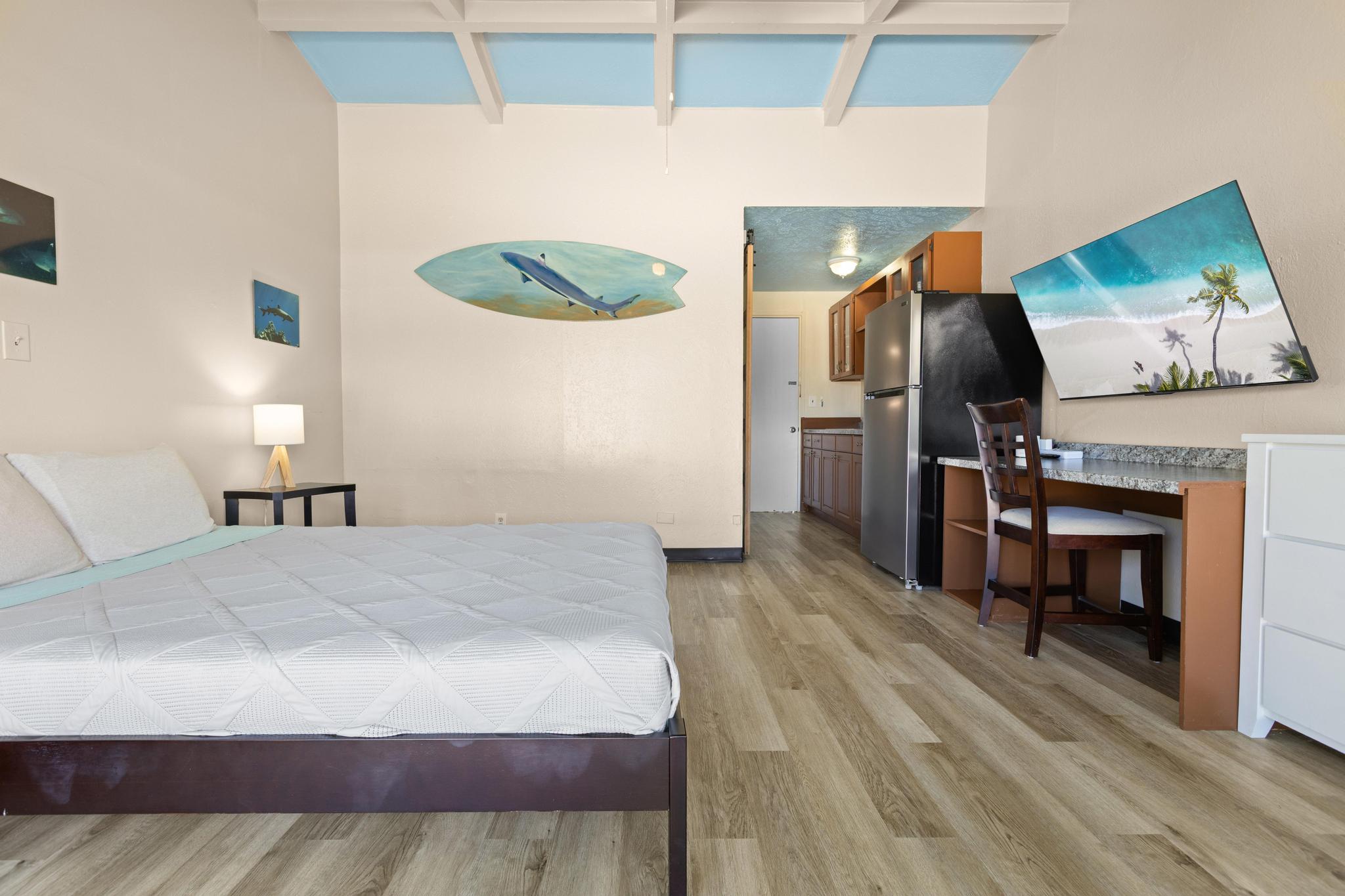 1303 Kalanianaole Street, Unit 112 Hilo, HI 96720 - Photo 20 of 27 a bedroom with a bed and a television