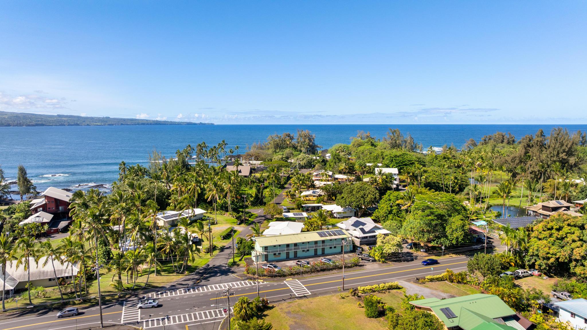 1303 Kalanianaole Street, Unit 112 Hilo, HI 96720 - Photo 25 of 27 a view of a city with lawn chairs and large trees