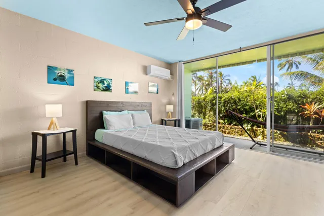 a living room with a bed furniture and a large window