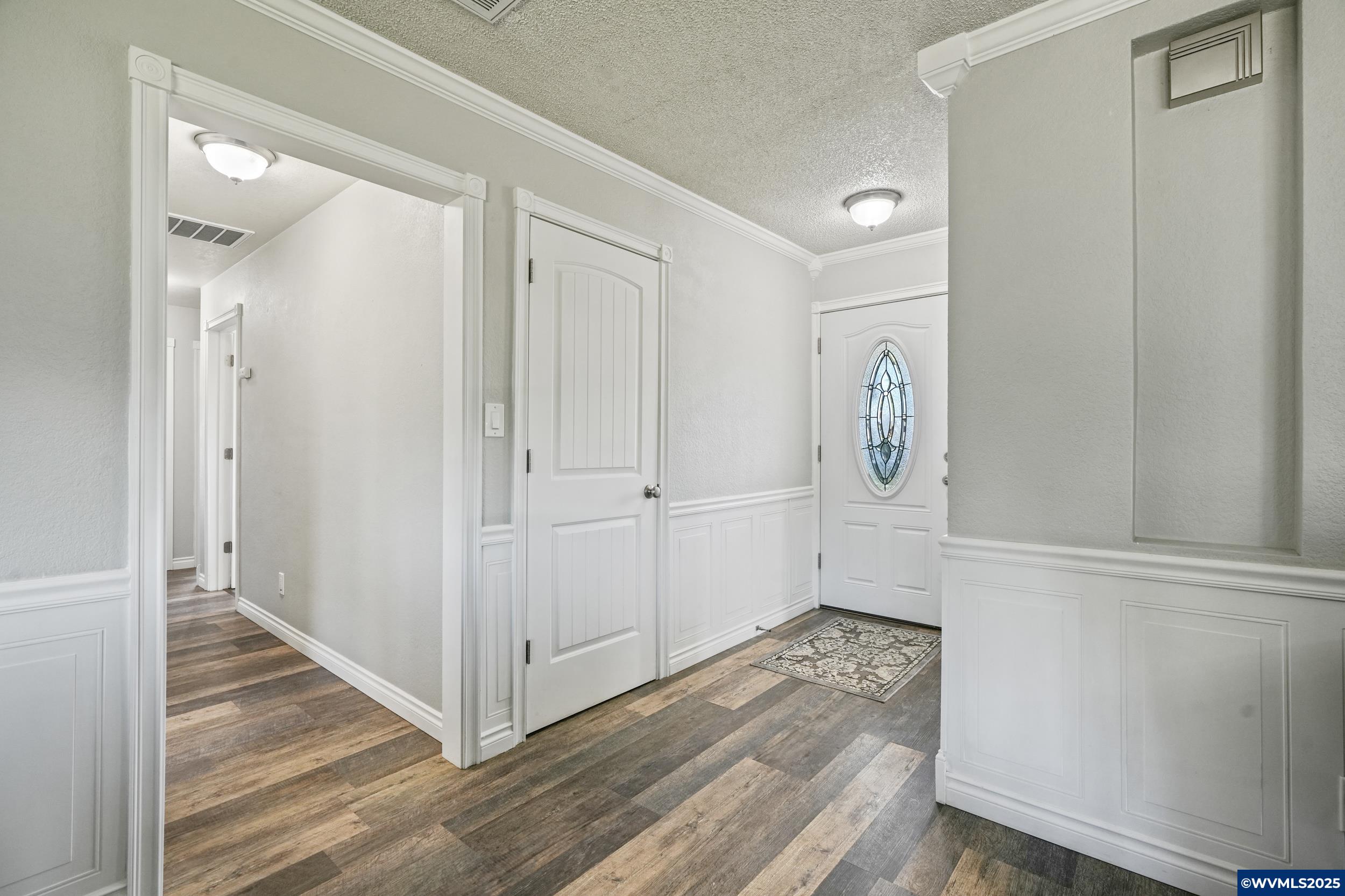 1023 37th Avenue Southwest Albany, OR 97321 - Photo 5 of 47 a view of a hallway with wooden floor and entryway