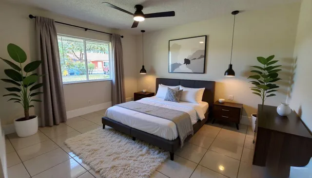 an empty room with windows and ceiling fan