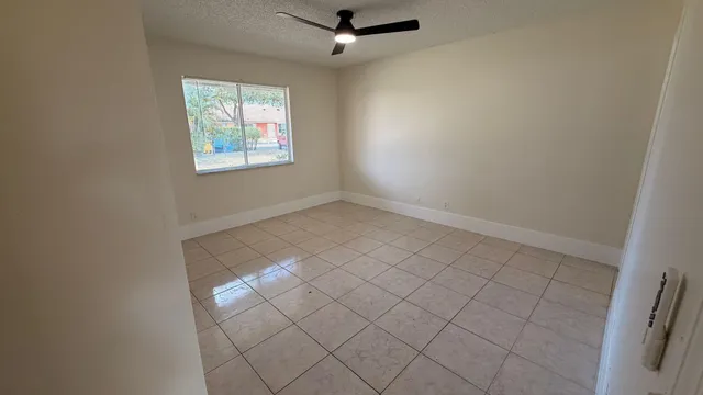 an empty room with ceiling fan