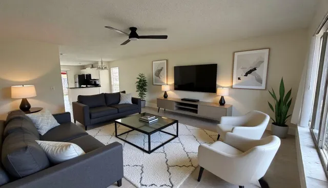 a living room with furniture and a flat screen tv