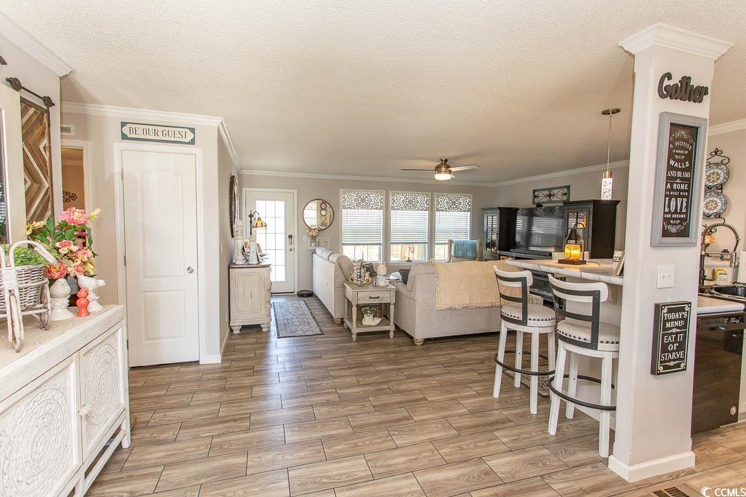 1664 Greenridge Drive Conway, SC 29526 - Photo 16 of 40 Living room with crown molding, a textured ceiling