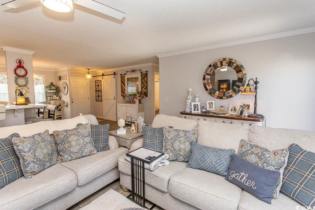 1664 Greenridge Drive Conway, SC 29526 - Photo 20 of 40 Living area featuring a barn door, ornamental mold