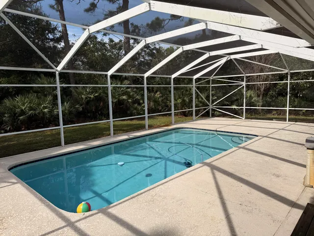 a view of a backyard with wooden floor and potted plants