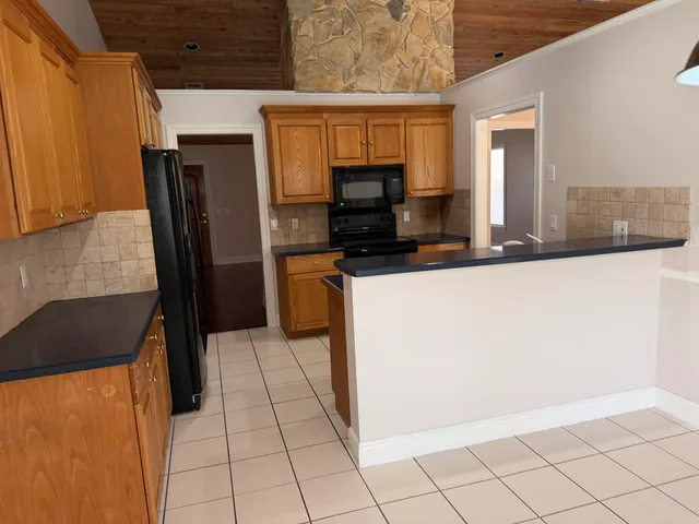 a kitchen with stainless steel appliances a refrigerator and a stove