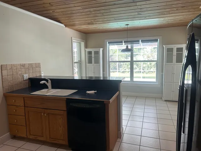 a kitchen with a sink a window a washer and dryer