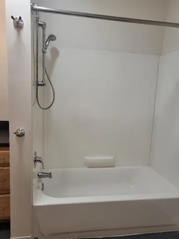 a bathroom with a shower and tub