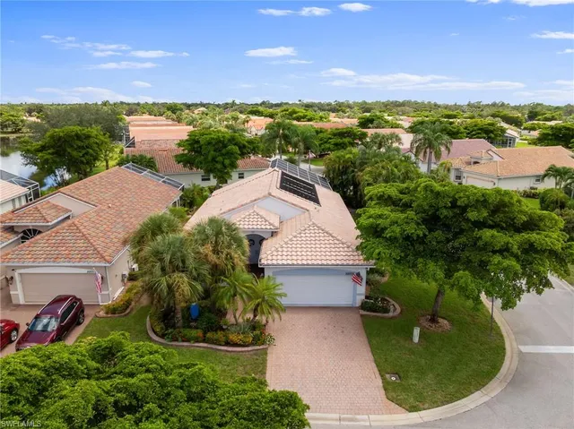 an aerial view of a house with a yard