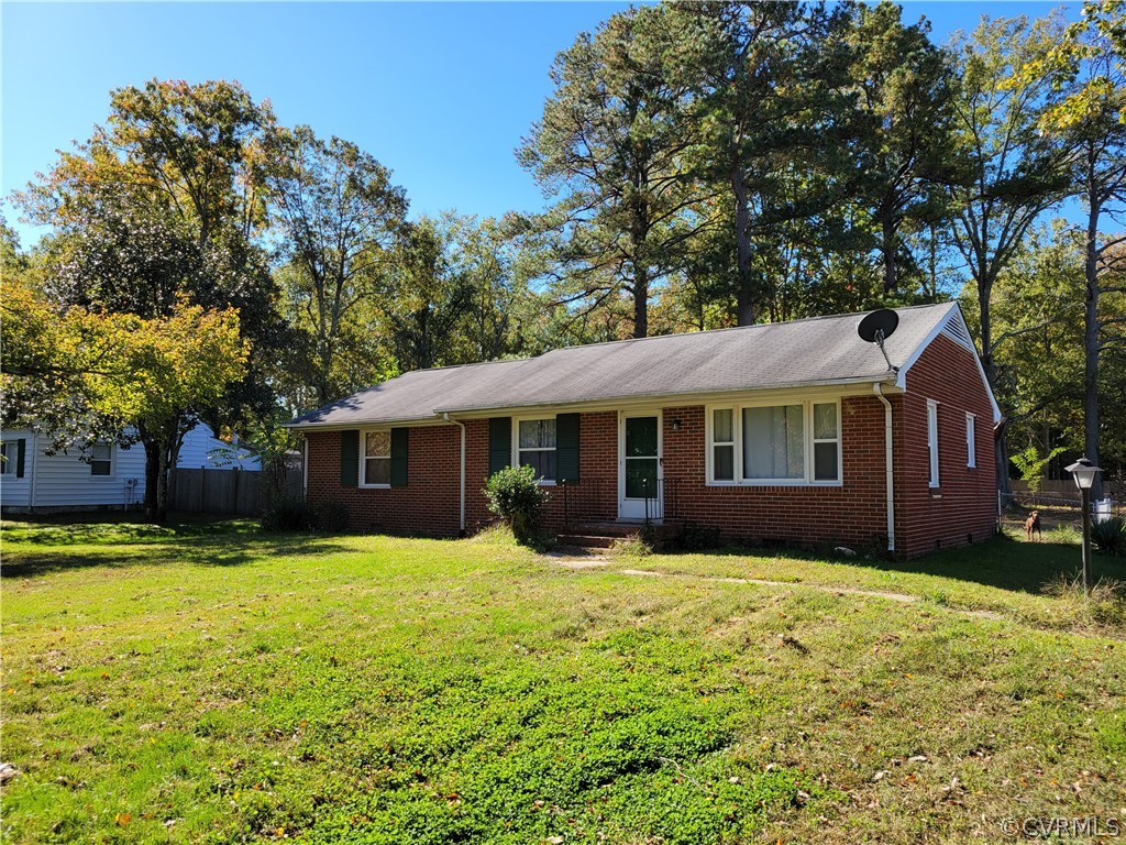 a front view of a house with yard and green space