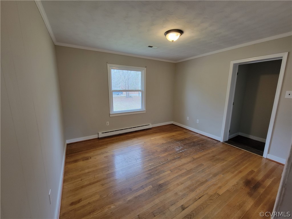 9016 Courthouse Road Chesterfield, VA 23832 - Photo 11 of 20 an empty room with wooden floor and windows