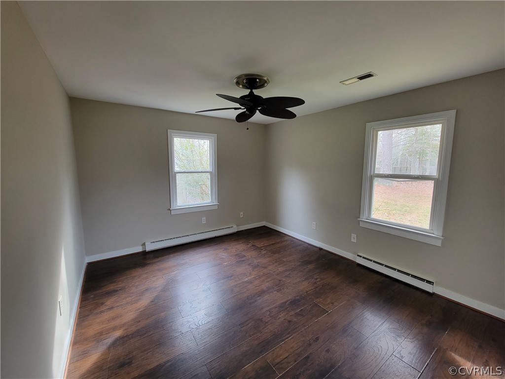 9016 Courthouse Road Chesterfield, VA 23832 - Photo 14 of 20 a view of an empty room with wooden floor and a window