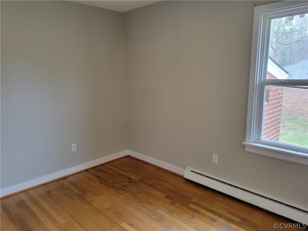 9016 Courthouse Road Chesterfield, VA 23832 - Photo 16 of 20 a view of an empty room with wooden floor and a window