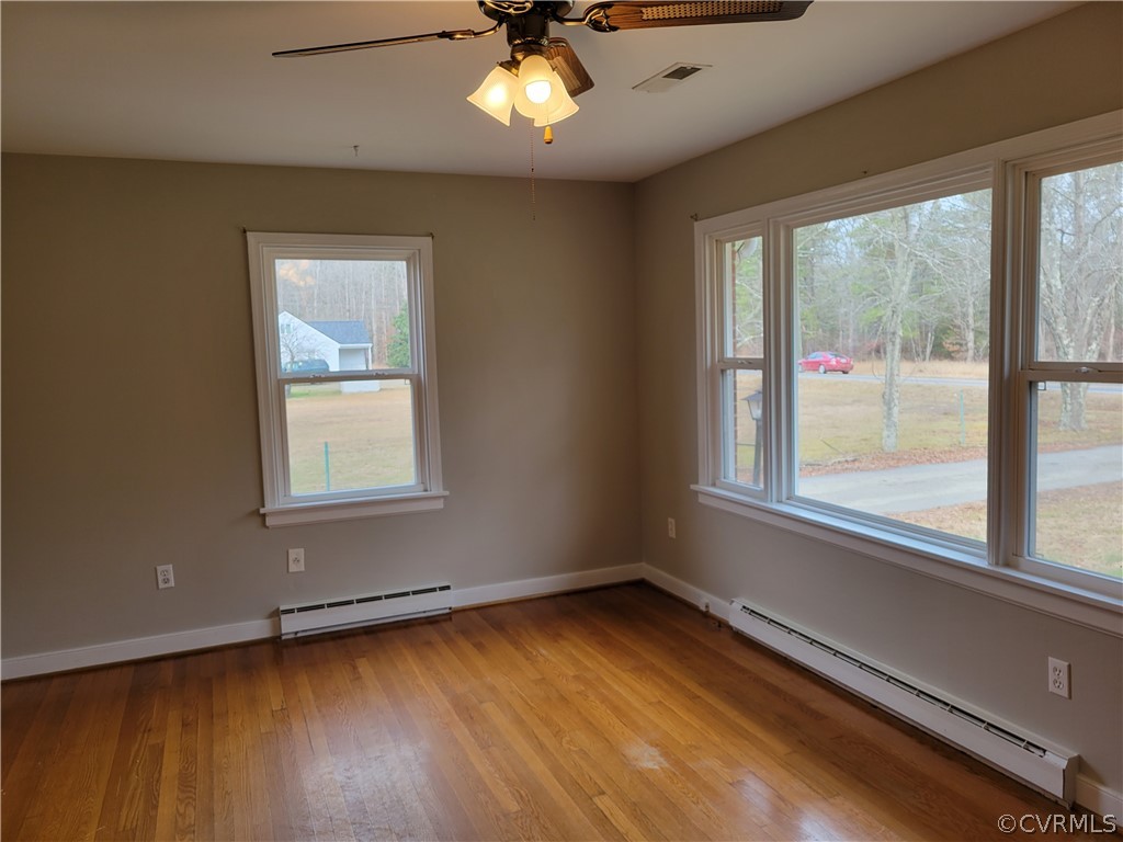 9016 Courthouse Road Chesterfield, VA 23832 - Photo 3 of 20 an empty room with wooden floor and windows
