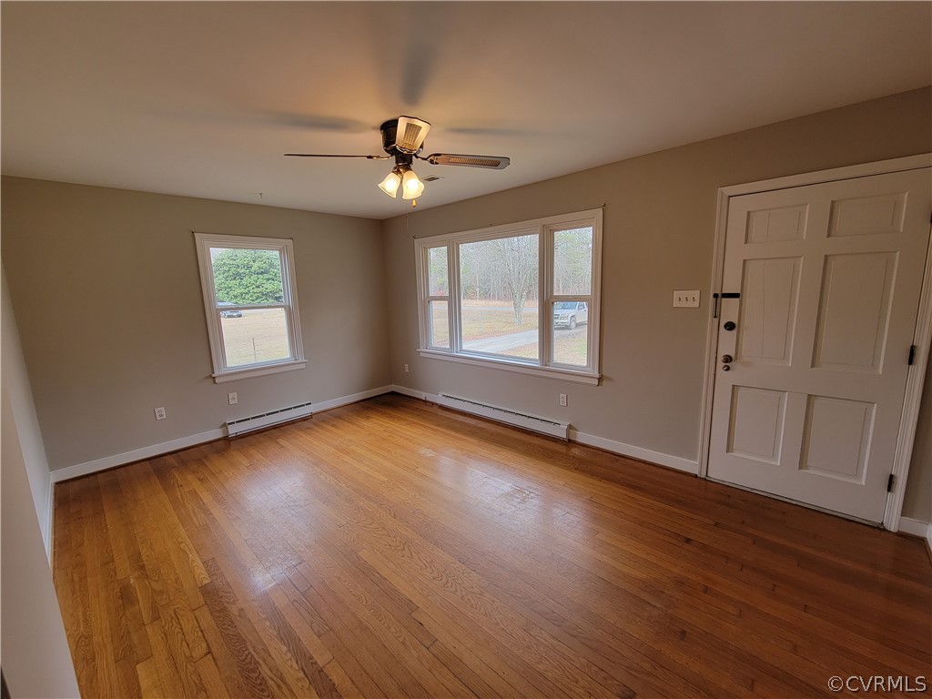 9016 Courthouse Road Chesterfield, VA 23832 - Photo 5 of 20 an empty room with wooden floor chandelier fan and windows