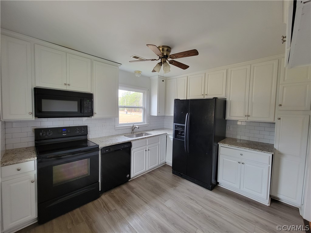 9016 Courthouse Road Chesterfield, VA 23832 - Photo 7 of 20 a kitchen with a refrigerator stove and sink