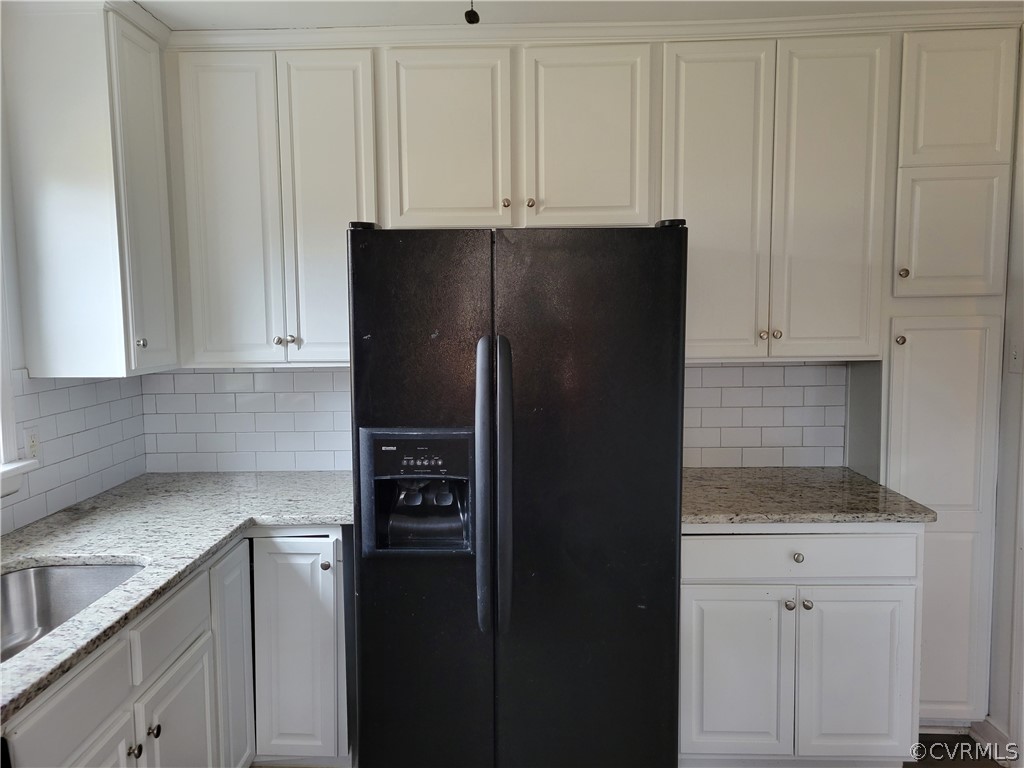 9016 Courthouse Road Chesterfield, VA 23832 - Photo 8 of 20 a kitchen with a refrigerator and cabinets