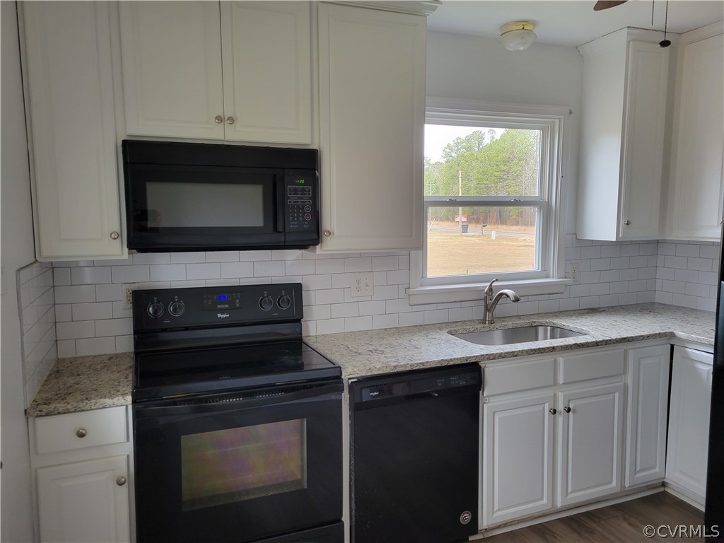 9016 Courthouse Road Chesterfield, VA 23832 - Photo 9 of 20 a kitchen with stainless steel appliances granite countertop white cabinets granite counter tops and a wooden floors