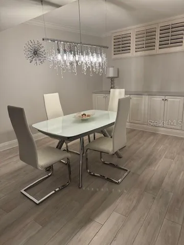 a view of a dining room with furniture and chandelier