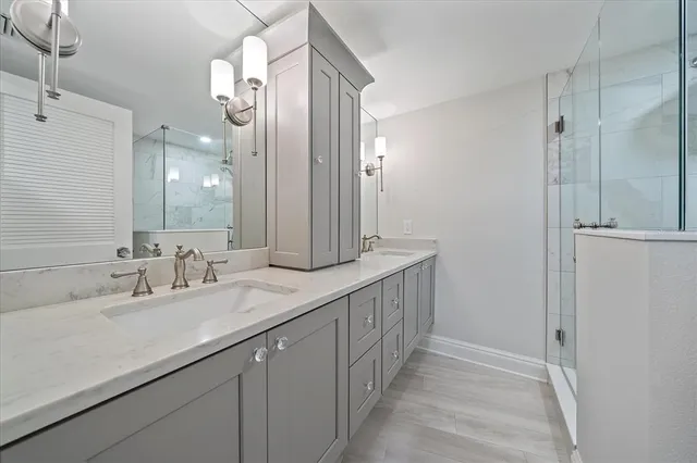 a bathroom with a double vanity sink and a mirror