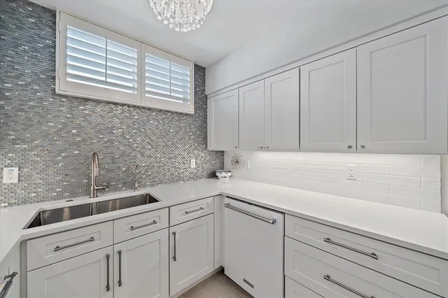 a kitchen with white cabinets and a sink