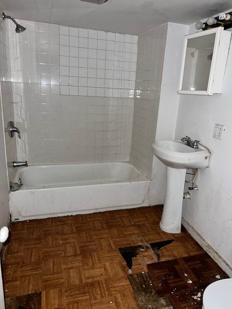 10614 South Langley Avenue, Unit 10614 Chicago, IL 60628 - Photo 9 of 11 a bathroom with a bathtub and shower