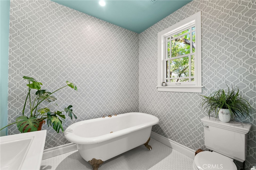 1688 Dwight Street Redlands, CA 92373 - Photo 12 of 72 a white bath tub sitting next to a white toilet and a sink