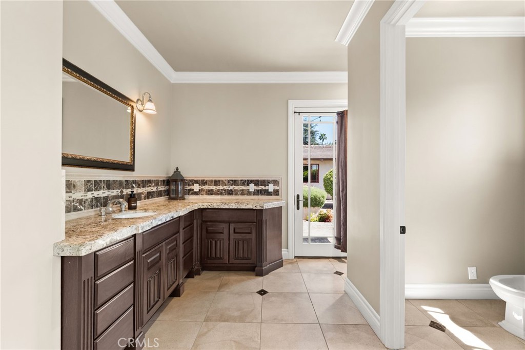 1688 Dwight Street Redlands, CA 92373 - Photo 17 of 72 a spacious bathroom with a granite countertop sink and a mirror