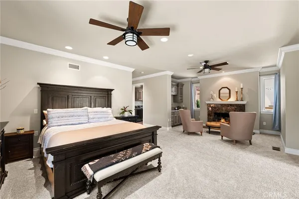 a large kitchen with a dining table chairs wooden floor and cabinets