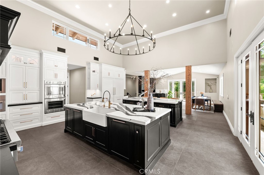 1688 Dwight Street Redlands, CA 92373 - Photo 24 of 72 a large white kitchen with a large window and stainless steel appliances