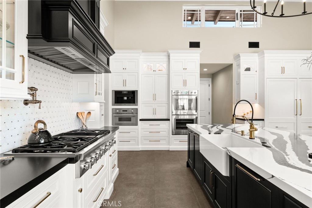 1688 Dwight Street Redlands, CA 92373 - Photo 25 of 72 a kitchen with stainless steel appliances a sink stove and cabinets