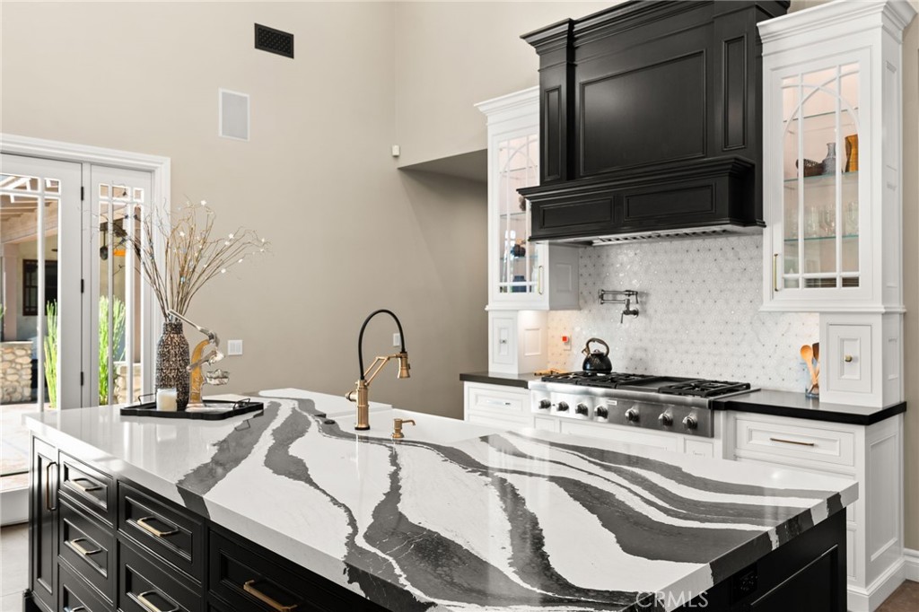 1688 Dwight Street Redlands, CA 92373 - Photo 26 of 72 a kitchen with a sink a stove and cabinets